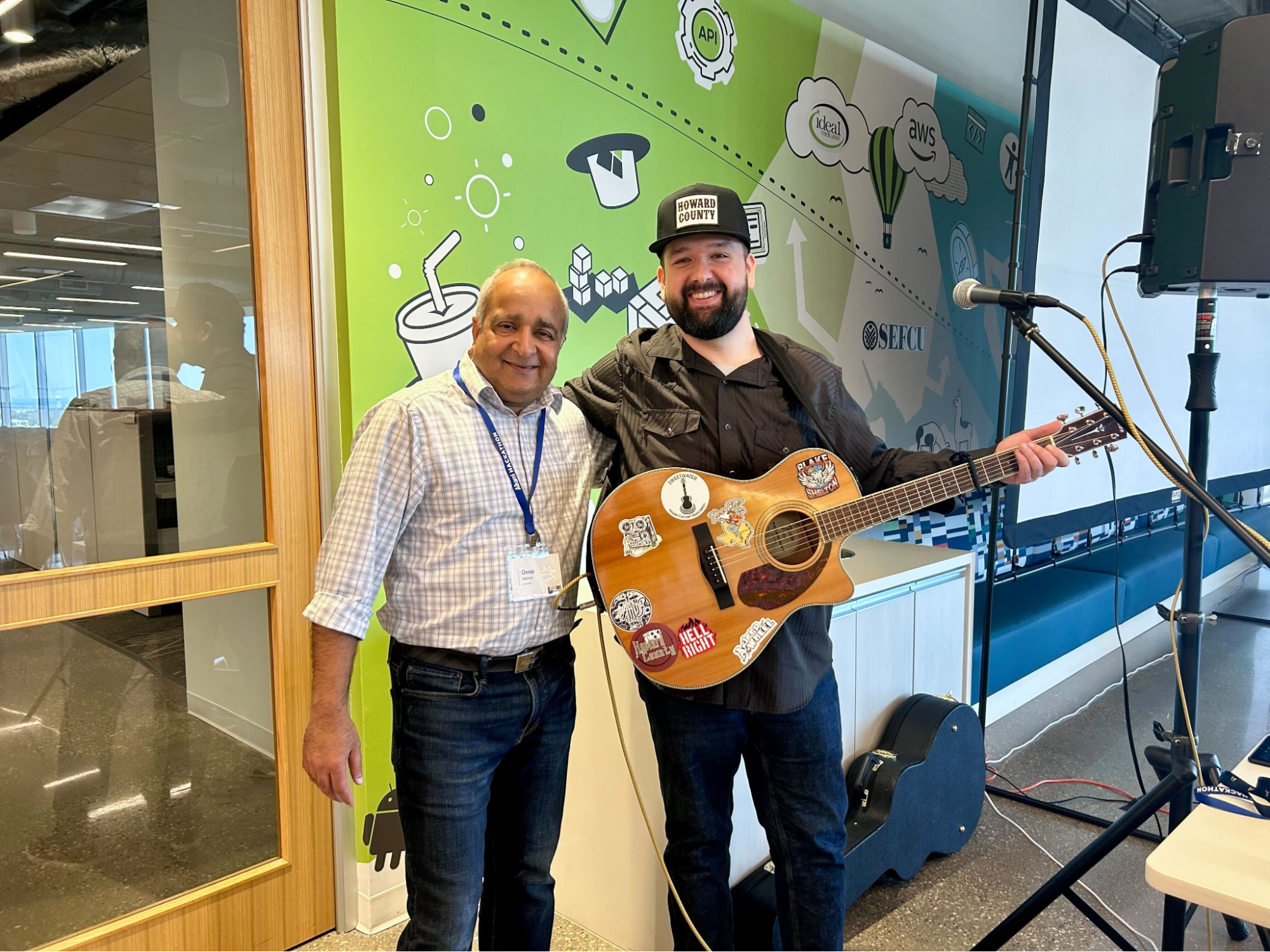 Engineer and CTO at hackathon celebrating teamwork on the digital banking platform; engineer also performed live music.