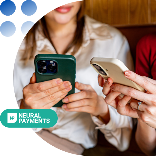 Two people seated, each holding a smartphone (green-back and white) as they perform a mobile payment, with a Neural Payments logo in the corner.