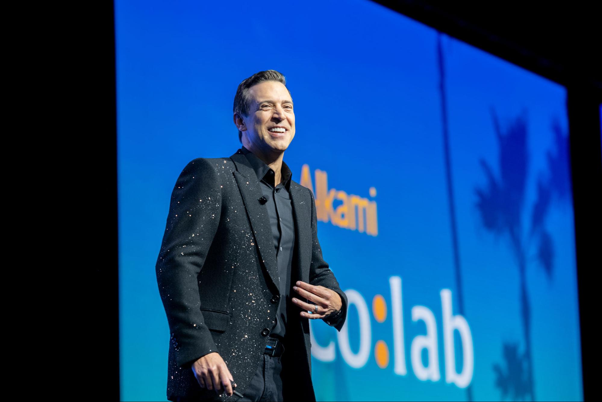 Bohanon-dazzling-suit - Alkami Technology Alkami Founder and Chief Strategy Officer Stephen Bohanon on the Alkami Co:lab mainstage greeting the audience
