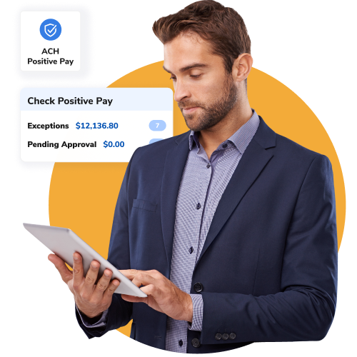 Businessman in a navy suit checks a tablet while a Positive Pay dashboard hovers beside him.