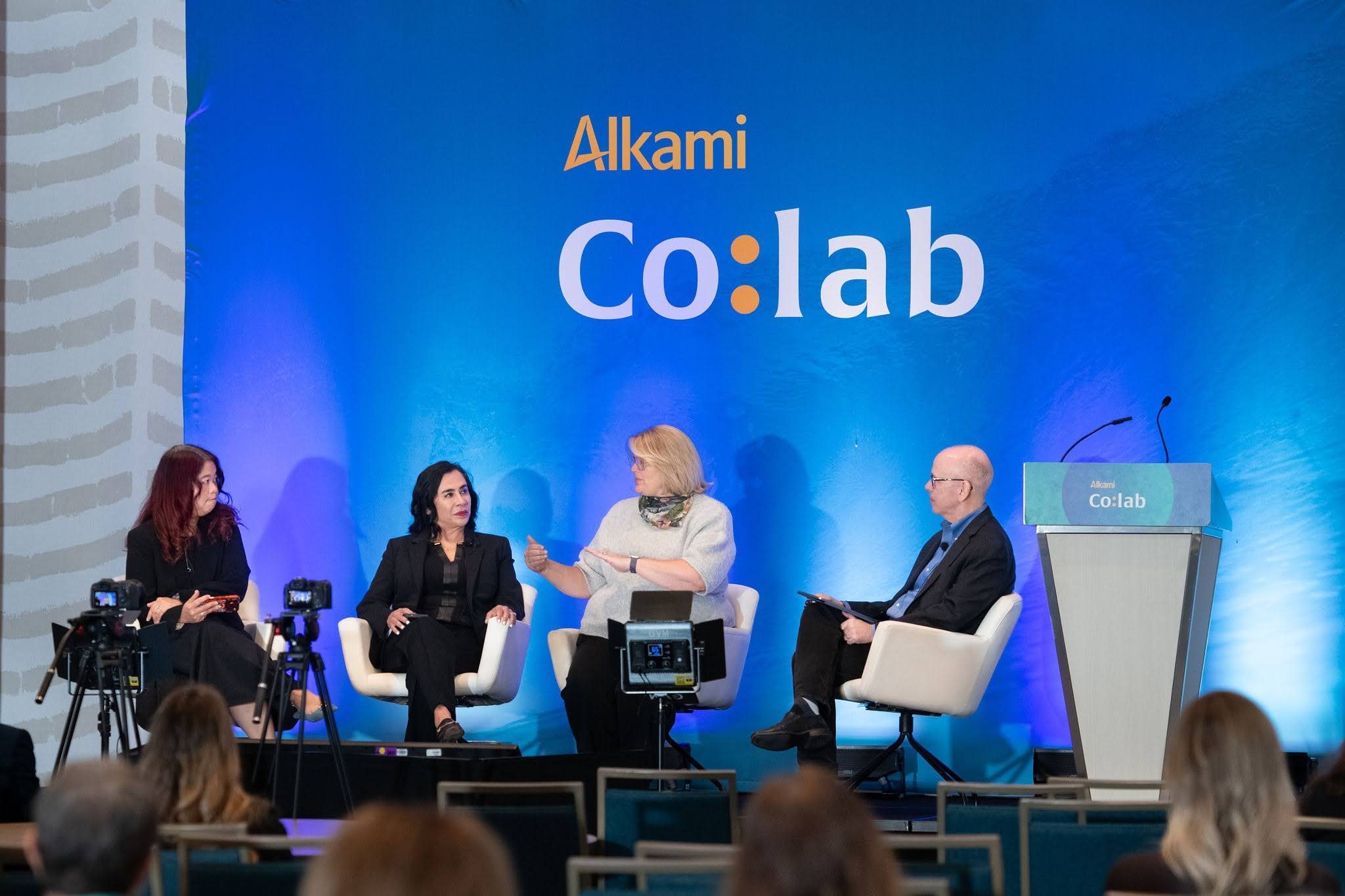 Theodora Lau, Tiffani Montez, Jennifer White, and Jim Perry speaking on stage at Alkami Co:lab 2026