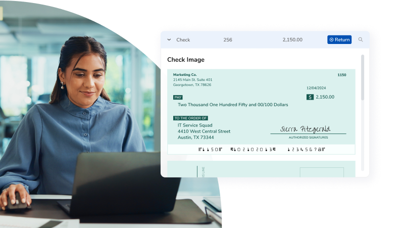 Woman working on a laptop while a digital check appears on the screen, representing online payment processing.