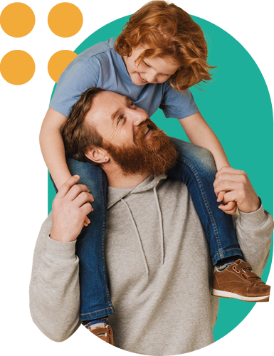 Father with a beard carries his smiling child on his shoulders in a playful moment.