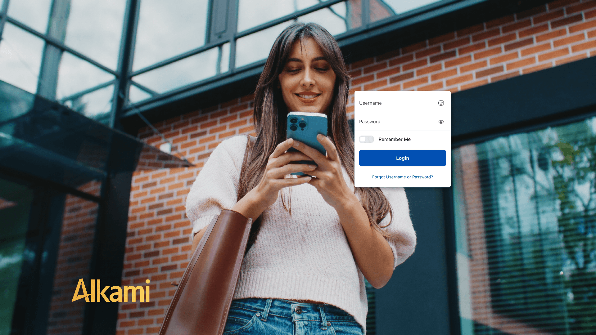 Woman in a light sweater outdoors, looking at her phone, with a white login modal showing Username, Password, Remember Me, and a blue Login button over a brick building background. (Alkami logo bottom left)