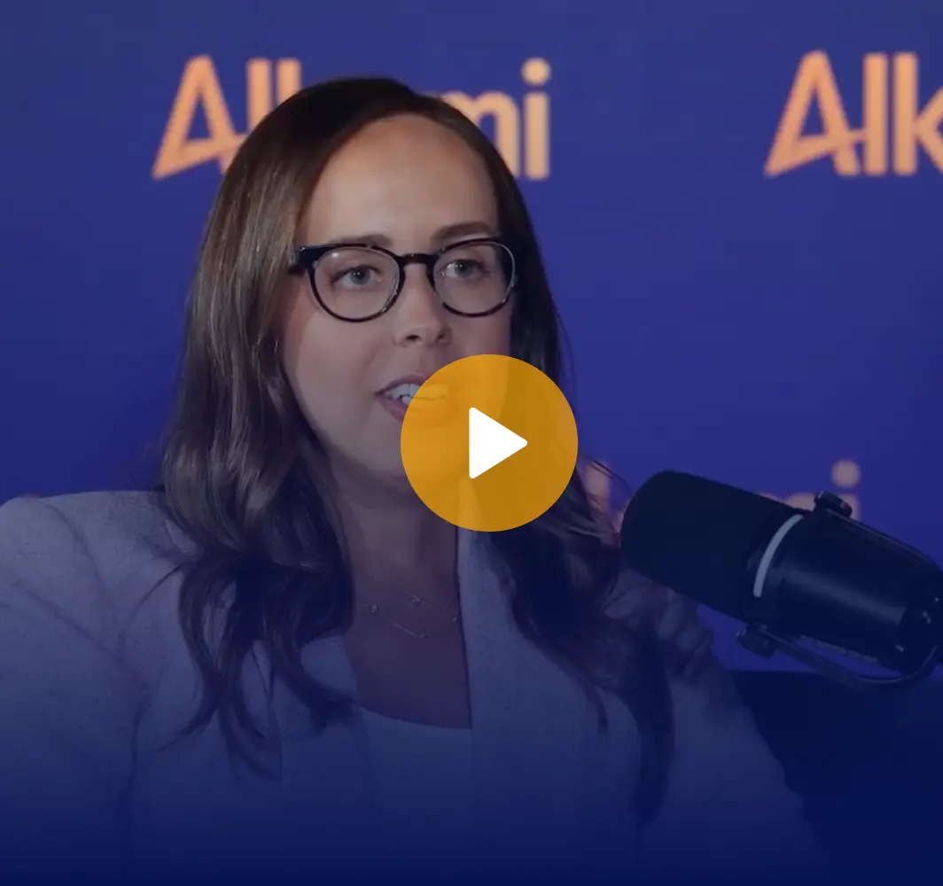 Video thumbnail of a woman with glasses speaking into a microphone against a blue 'Alkami' backdrop.
